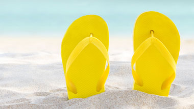 Flip Flops in the sand at the beach.