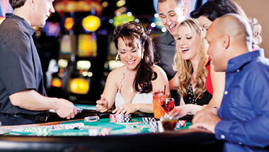 People playing and laughing at a Baccarat table