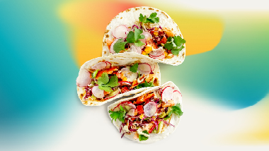 3 tacos with citrus colors in background