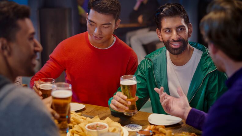 A group of friends enjoying drinks and food at ESPN BET